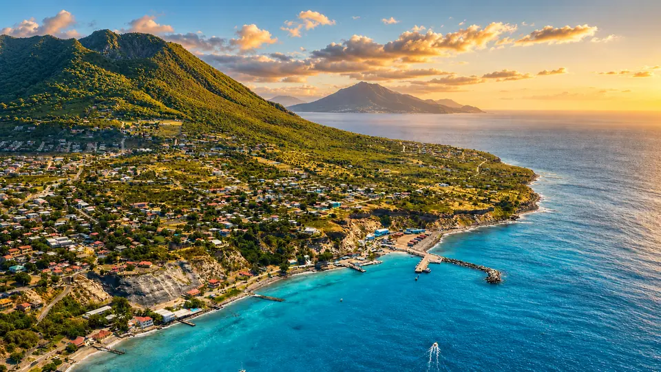 An aerial view across Sint Eustatius, its coastline and neighbouring islands at sunset